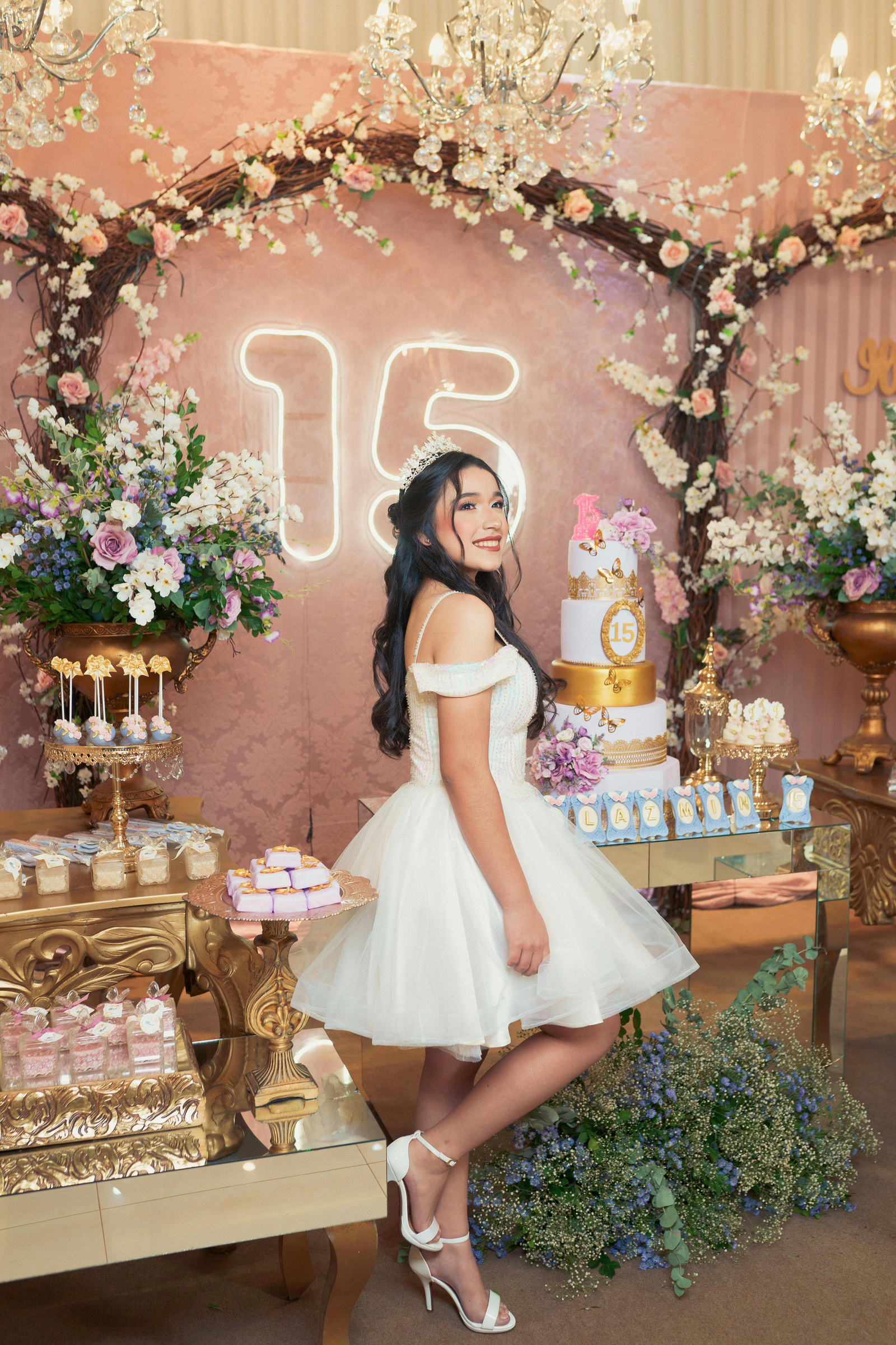 A Quinceañera Posing by her Birthday Cake